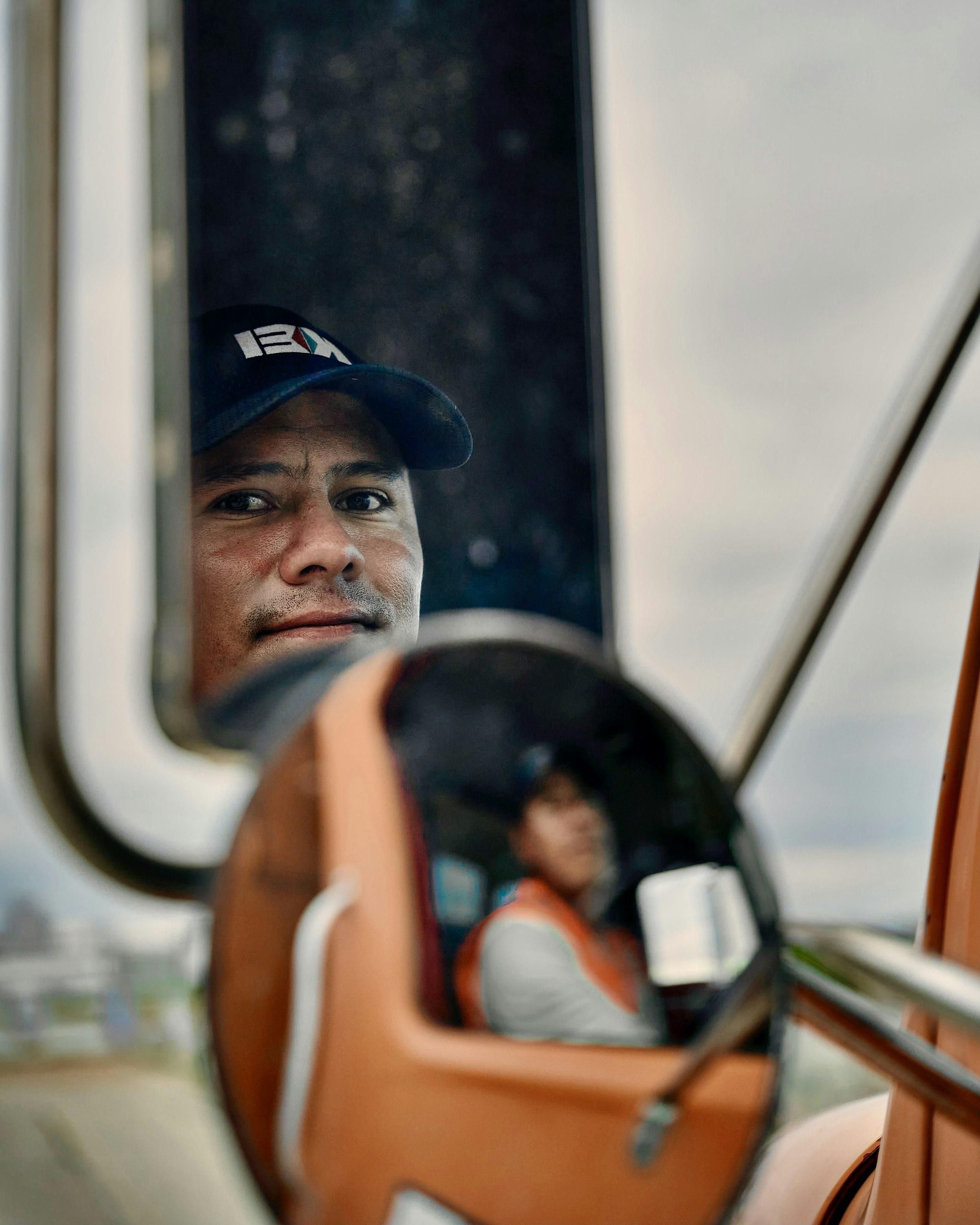 Truck driver in the cab of a semi-truck